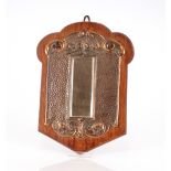 An oak and spot hammered copper mounted mirrored h