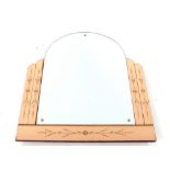 An Art Deco frameless arched and bevelled wall mir