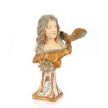 A glazed plaster bust of an Art Nouveau lady with