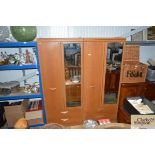 A pair of pine effect mirror fronted wardrobes fit