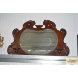 A mahogany over mantel mirror