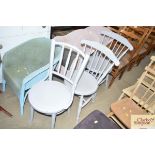 A pair of stick back grey painted chairs together