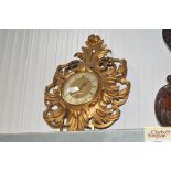 A gilt framed clock