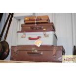 A quantity of vintage suitcases