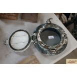 A brass circular glazed porthole