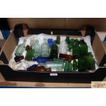 A box of various vintage glass bottles