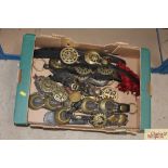 A box containing numerous horse brasses hung to le