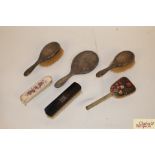 Three silver backed dressing table items and three