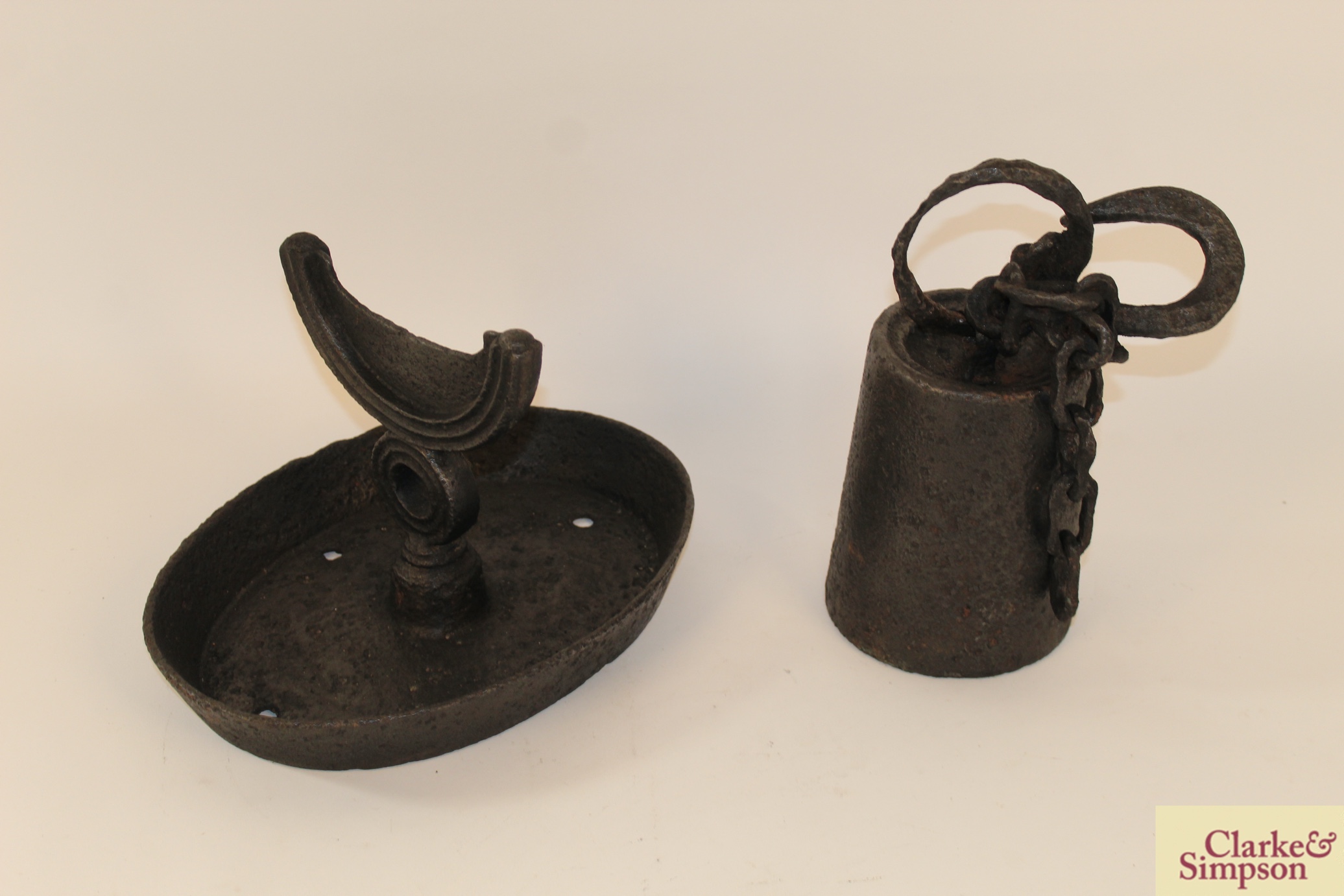 A cast iron boot scraper and a cast iron weight w