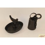 A cast iron boot scraper and a cast iron weight w