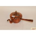 An antique copper side pouring kettle