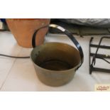 A brass preserve pan with iron loop handle