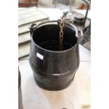 A riveted metal well pail with chain