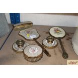 A brass gilt metal and embroidered dressing table