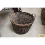 A large rustic wicker log basket