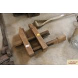 A pair of vintage wooden carpenters clamps