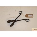 A pair of antique iron tongs