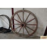 A painted wooden cartwheel with iron rim