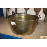 A brass preserve pan with iron swing handle