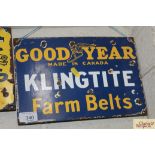 A "Goodyear Klingtite Farm Belts" enamel advertisi
