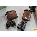 Two pairs of leather cased vintage binoculars, one