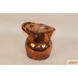 An antique copper pail with twin lidded top and sw