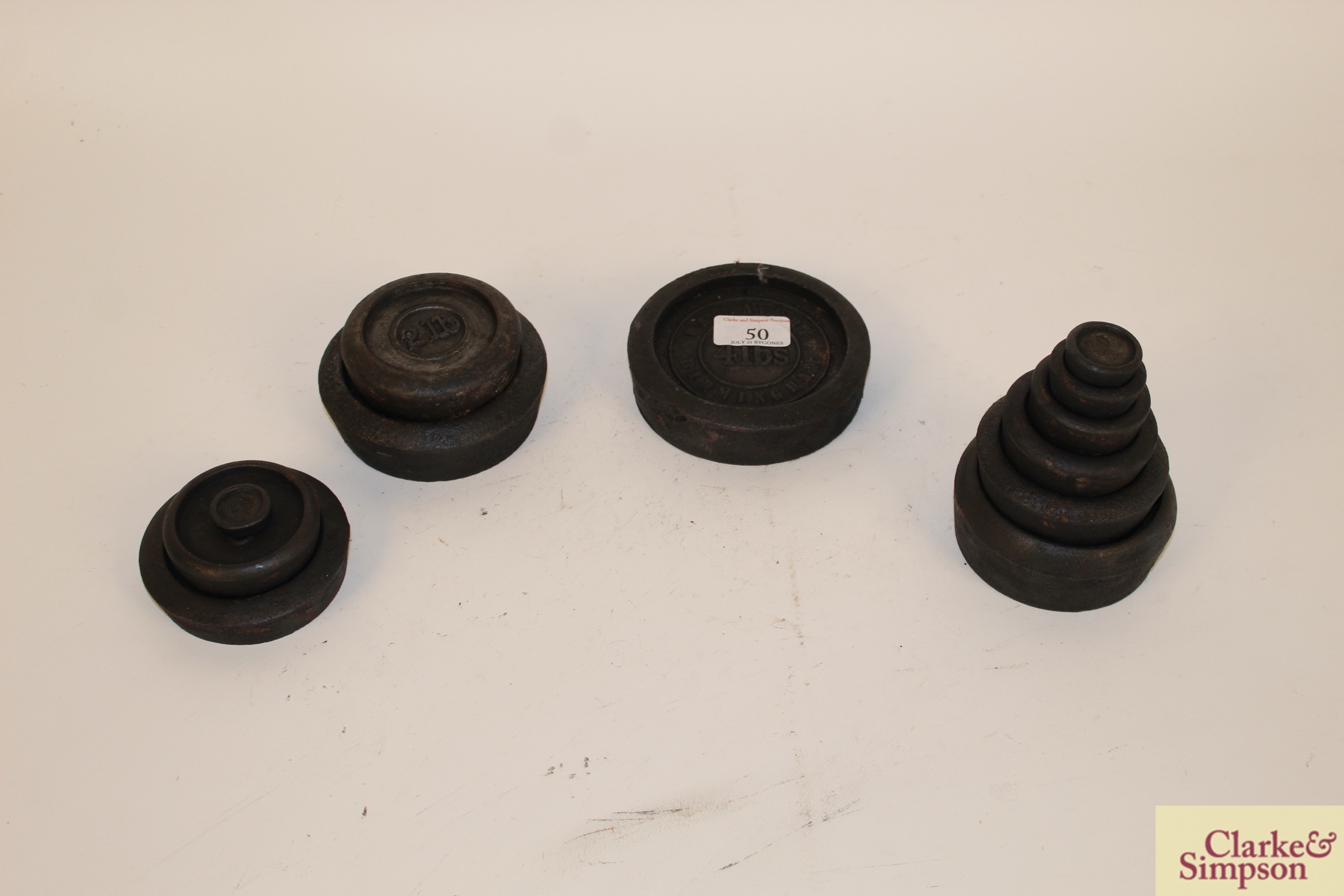 A collection of various iron shop scale weights