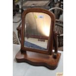 A mahogany swing frame toilet mirror