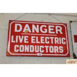 An enamel sign "Danger Live Electric Conductors",