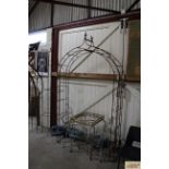 A wrought metal garden rose arch