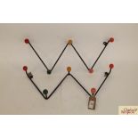 Two metal ware and plastic zigzag coat racks