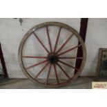 A painted wooden cartwheel with iron rim