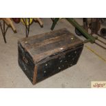 A large wooden bound travelling trunk with carryin