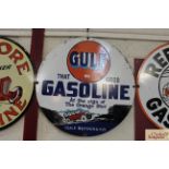 A circular enamel advertising sign for "Gulf Gasol