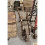A single wheel cast iron vintage barrow for a stat