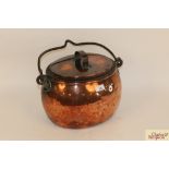 An antique copper cauldron shaped boiling pan with