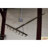 A vintage wooden rustic hay rake