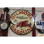A circular enamel advertising sign for "Gilmore Ga