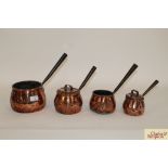 Four antique copper graduated saucepans (two with