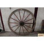 A painted wooden cartwheel with iron rim