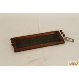A small wooden two handled tray with clover leaf d