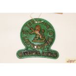A Ransomes Ipswich cast iron badge "The Lion Lawn M