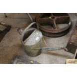 A galvanised two gallon watering can