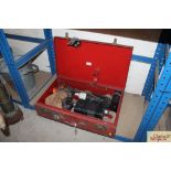 A vintage red metal case containing various fire r