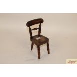 A 19th Century miniature kitchen chair with good p