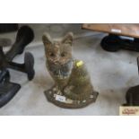 A cast iron door stop in the form of a seated cat