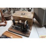 An ornate cased hand sewing machine