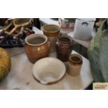 Four glazed stoneware storage jars and a large si