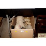 A box containing various Teddy bears and toys
