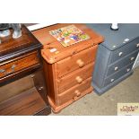 A pine bedside chest fitted with three drawers